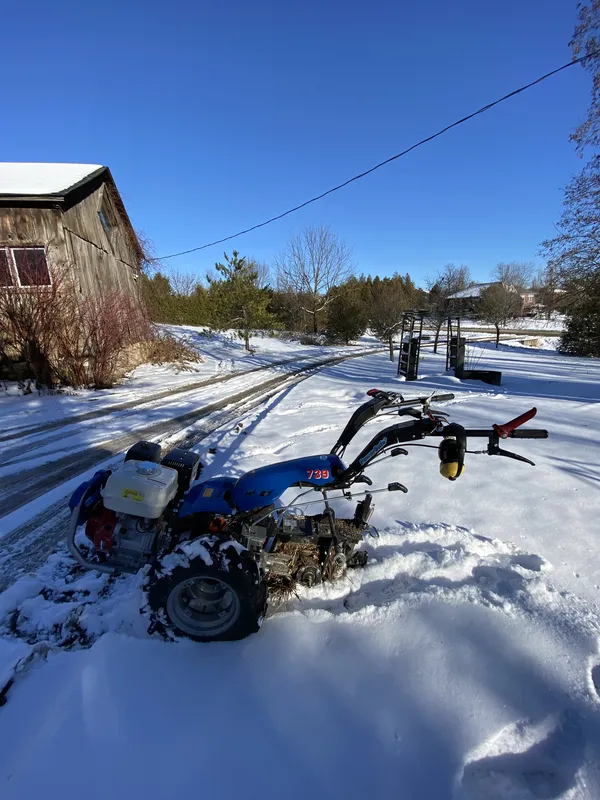 Wire burial trenching equipment during winter installation — Wellington County